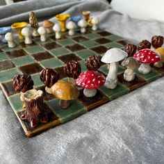 a close up of a chess board with mushrooms on it and other figurines