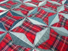 a red and blue quilt with stars on it