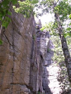 a man climbing up the side of a cliff