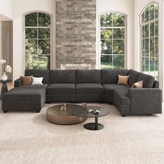 a living room with large windows and a sectional couch