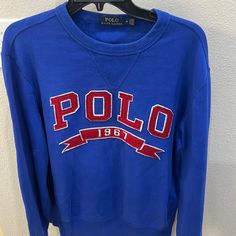 Royal Blue Polo 1967 Ribbon Sweatshirt. The Colors On This Shirt Are Excellent Condition. Looks Brand New. Casual Blue Tops With Embroidered Logo, Blue Casual Top With Embroidered Logo, Casual Blue Top With Embroidered Logo, Casual Long Sleeve Tops With Embroidered Logo, Blue Cotton Crew Neck Top, Sporty Crew Neck Blue Top, Blue Logo Print Sweater For Fall, Blue Casual Sweatshirt With Logo Print, Fall Blue Sweater With Logo Print