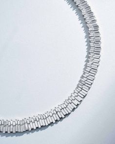 This exquisite tennis necklace is crafted from 18-karat gold and showcases 10.92 carats of radiant white diamond baguettes, artfully arranged in Suzanne's signature asymmetric setting. The design is enhanced with solid gold elements that echo the shape of the baguette diamonds adding depth to the piece. Designed for comfort, the necklace offers a seamless and flexible fit, ensuring it feels as delightful to wear as it looks. Details 18k yellow gold, rose gold or white gold 10.92 carats of white Baguette Necklace Diamond, Baguette Diamond Necklace, White Diamond Necklace, Baguette Necklace, Diamond Tennis Necklace, Baguette Diamonds, Baguette Cut Diamond, Tennis Necklace, Baguette Cut