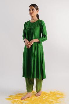 Green slub silk A-line kurta with beaded hand embroidered neckline, yoke and sleeve hems. Comes with tissue pant.
Components: 2
Pattern: Hand embroidered
Type Of Work: Beads
Neckline: Round
Sleeve Type: Three quarter
Fabric: Kurta : Slub silk, Pant : Tissue
Color: Green
Other Details: 
Closure : Kurta - Back potli buttons
Occasion: Puja - Aza Fashions Navratri Long Sleeve Kurta With Yoke, Chanderi Long Sleeve Kurta With Yoke, Eid Cotton Kurta With Embroidered Neckline, Cotton Kurta With Yoke For Navratri, Navratri Cotton Kurta With Yoke Detail, Silk Kurta With Embroidered Neckline And Long Sleeves, Cotton Silk Straight Kurta With Yoke, Traditional Straight Kurta With Embroidered Neckline, Eid Long Sleeve Kurta With Yoke Detail