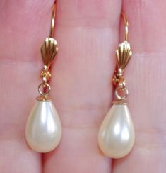 Old stock vintage 14k gf 35 mm golden teardrop majorca pearl leverback earrings welcome to my handmade store: hand made 14k gold filled 35 mm white / golden perfect tear drop white / golden majorca pearl leverback earrings these earrings are hobe old stock pearls from spain. they are from hobe comoany. some have discolorations but i cleaned them. some might have some not vidsible scraches or minor cracks on top drills on the upper coating part which might not be seen on drill part which is cover Vintage Teardrop Pearl Drop Earrings, Vintage Teardrop Pearl Earrings For Anniversary, Vintage Pear-shaped Formal Earrings, Vintage Pear-shaped Earrings For Formal Occasions, Dainty Drop Pearl Earrings For Formal Occasions, Vintage Teardrop Pearl Earrings, Vintage Gold Teardrop Pearl Earrings, Vintage Pear-shaped Pearl Drop Jewelry, Dainty Teardrop Pearl Earrings For Formal Occasions