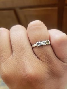 a person's hand with a ring on it