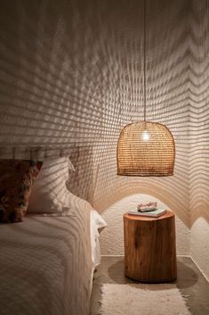 a bed room with two beds and a lamp on top of the headboard next to each other