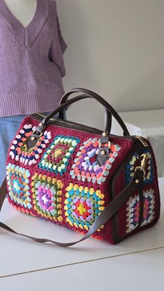 Crochet Zippered Duffle  bag with Colorful Granny Square Vintage Motifs -top handle everyday crossbody bag in Retro design  This versatile bag is perfect for all your needs--whether you're heading out. Size: Measurements: 40 cm (length) x 25 cm (height) x 20 cm (width) x 11 cm Design: Fully zippered closure for security and ease. Interior: Lined with luxurious suede leather for an elegant touch and durability. zippered inside pocket Has an adjustable and detachable long shoulder leather strap fo Crochet Duffel Bag, Vintage Crochet Travel Bag Rectangular, Retro Crochet Travel Bag, Rectangular, Granny Square Vintage, Handmade Retro Square Crochet Bag, Multicolor Retro Crochet Bag With Granny Square Details, Retro Multicolor Square Crochet Bag, Colorful Granny Square, Vintage Motifs