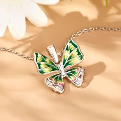 Add sparkle to your look with this butterfly-inspired necklace. Beautiful enamel design with vibrant colours and wings that'll define the Spirit of You. This intricate design is handcrafted using the legendary art of enameling, with sparkling stones that recreate the charm of the butterfly. Inspired by the beauty of nature, this will brighten up even the dullest of days in your life. Vibrant and full of life, this beautiful butterfly is ready to land in your jewelry box.Carat Weight: 0.479 ctSto Multicolor Butterfly Charm Necklaces, Green Butterfly Charm Pendant Necklace, Green Butterfly Charm Necklace, Elegant Multicolor Butterfly Necklace As A Gift, Elegant Multicolor Butterfly Necklace Gift, Elegant Multicolor Butterfly Necklace As Gift, Elegant Green Butterfly Necklace, Multicolor Butterfly Charm Jewelry, Multicolor Butterfly Print Jewelry Gift