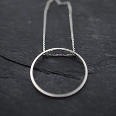 Singular rolling Oh silver necklace by Minicyn on Etsy Modern Circle Clavicle Chain Necklace, Circle Sterling Silver Necklace In White Gold, White Gold Sterling Silver Circle Necklace, Modern Necklace With Delicate Chain And Round Pendant, Modern Round Chain Necklace For Everyday, Modern Sterling Silver Chain Necklace With Round Pendant, Modern Sterling Silver Round Pendant Chain Necklace, Modern White Gold Necklaces With Open Circle, Everyday Circle Necklace With Chain