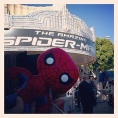 a giant spider man statue in front of the amazing spider - man theater