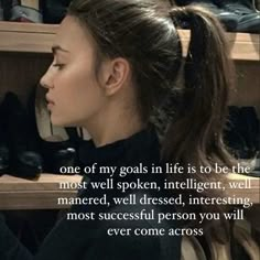 a woman is looking at her shoes in the closet with a quote on it that says, one of my goals life is to be the most well