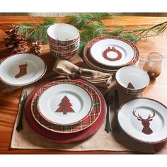 a christmas table setting with plaid and deer head plates, napkins, silverware and pine cones