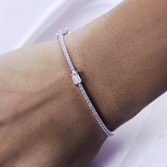 Add a touch of elegance to any outfit with our Emerald & Round White Cubic Zirconia Tennis Bangle Bracelet. Crafted from 925 sterling silver, this bracelet exudes sophistication and luxury. The perfect accessory for the refined woman, it combines the classic tennis bracelet design with a modern twist, featuring vibrant emerald and sparkling round white cubic zirconia stones. Elevate your style with this exquisite piece.Model No : CSBN11223-CZ Elegant Diamond Bracelet With Sparkling Stones As Gift, Sterling Silver Bracelet With Sparkling Stones, Elegant Sterling Silver Bracelet With Sparkling Stones For Anniversary, Dainty Diamond Bracelet With Sparkling Stones For Formal Occasions, Elegant Tennis Bracelet With Sparkling Stones For Gift, Sterling Silver Bracelets With Prong Setting, Elegant White Gold Bracelet With Sparkling Stones, Classic Diamond Bracelet With Sparkling Stones For Gift, Classic Diamond Bracelet With Sparkling Stones As Gift