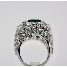 This is part of Chairish’s Fine Jewelry assortment.  Oval Emerald 12.25 Carat Diamond Surround 8.85 Carat Total Weight 21.10 Carat  This oval Emerald weights in at 12.25 carats and is a gorgeous Emerald Green with transparency. The Diamonds weigh in at 8.85 Carats and the mount is exceptional the Diamonds are VS1-VS2 and G-J in color. This is a bombe mount. The shoulders of the ring are embellished with baguette cut Diamonds in the center border with a perimeter of round cut Diamonds accents. Th Luxury Marquise Emerald Ring With Diamonds, Luxury Marquise Emerald Ring, Luxury Pear-shaped Diamond Ring With 17 Jewels, Luxury Pear-shaped Emerald Ring For Formal Occasions, Platinum Oval Emerald Ring With 17 Jewels, Oval Platinum Emerald Ring With 17 Jewels, Luxury Pear-shaped Brilliant Cut Emerald Ring, Luxury Platinum Pear-shaped Rings, Luxury Pear-shaped Platinum Rings