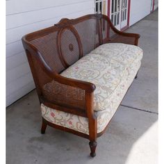 a wooden bench sitting next to a white house