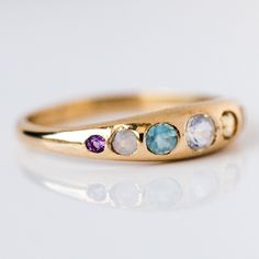 Yowza... The She's an Artist Ring is a serious showstopper. Pink opal, peach moonstone, citrine, opal, aquamarine, chalcedony, amethyst on front with a teeny tiny rainbow moonstone on the back! Love is an understatement, we're obsessed! Pink opal 1.5mm Peach moonstone 2mm Citrine 2.5mm Opal 3mm Aquamarine 2.5mm Chalced Fine Jewelry Opal Ring With Multi-stone For Anniversary, Luxury Multi-stone Crystal Ring For Anniversary, 14k Gold Multi-stone Opal Ring, Yellow Gold Multi-stone Opal Ring For Anniversary, Heirloom Multi-stone Opal Ring For Anniversary, Promise Jewelry Multi-stone Round Band, Promise Multi-stone Round Band Jewelry, Yellow Gold Multi-stone Moonstone Ring For Anniversary, 14k Gold Opal Ring With Multi-stone Round Cut