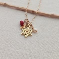 "Jewish necklace. Judaica jewelry. Dainty Magen David pendant. Gold star of David pendant. Women's gift. Jewish gift. 14K Gold filled. Hamsa hand. Protection jewelry Small 14K Gold Filled hamsa hand pendant. Paperclip 14K Gold Filled chain 1 ruby gemstone small bead, 1 freshwater pearl  This necklace measures in length 16\" + 1 inch extender chain You can choose your length! I include always a free surprise gift with every order All items are wrapped individually in a gift box Shipment arrives i Gold Charm Necklaces Perfect For Gifts, 14k Gold Jewelry With Star Charm Gift, Star Charm Pendant Jewelry Gift, 14k Gold Star Charm Jewelry Gift, Star Of David Necklace For Gift, Dainty Star Of David Charm Necklace For Gift, Gold Star Jewelry For Mother's Day, Spiritual Jewelry With Star Charm For Gift, Gold Star Of David Charm Necklace As Gift