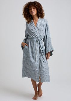 The charming Corina robe is cut from our inimitable cotton and adorned with an interesting blue Ditsy floral print. This oversized kimono-inspired robe boasts fluted sleeves and a detachable belt, creating a flattering silhouette. Contrast piping on the cuff and neck, complete this effortlessly feminine piece.    Cool machine wash only. Wash inside out and with similar colours 100% Cotton Modal   Cool machine wash only. Wash inside out and with similar colours Oversized Kimono, Fluted Sleeves, Luxury Scarves, Printed Robe, Floral Robes, July Birthstone Jewelry, Ditsy Floral Print, Nightwear Women, Contrast Piping