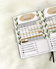 two planner pages with leaves on them sitting on top of a white furnishing