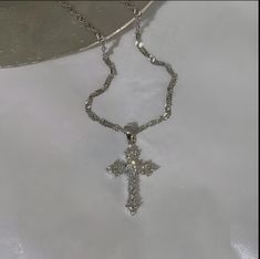 Discover the perfect blend of elegance and spirituality with our stunning Silver Cross Necklace. Crafted with intricate detailing, this necklace features a beautifully designed cross pendant adorned with sparkling stones that catch the light beautifully. The unique pattern of the chain adds a touch of sophistication, making it an ideal accessory for any occasion, from casual outings to formal events. This necklace not only serves as a fashion statement but also carries a deeper meaning, symbolizing faith and elegance. Whether you're purchasing it for yourself or as a meaningful gift for someone special, it's sure to be cherished. Features: Material: High-quality silver with a shimmering finish Pendant Size: [Insert size, e.g., 2.5 inches] Chain Length: [Insert length, e.g., 18 inches] Weig Silver Jewelry Streetwear, Silver Necklaces Cross, Cross Silver Necklace, Cute Necklaces Silver, Cross Necklace Outfit, Cute Cross Necklace, Cross Necklace Aesthetic, Chunky Cross Necklace, Silver Diamond Cross Necklace