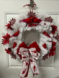 a white wreath with red and white decorations