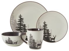 the black and white dinnerware is decorated with deer, pine trees, and snowflakes