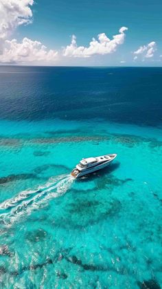 a boat in the middle of clear blue water