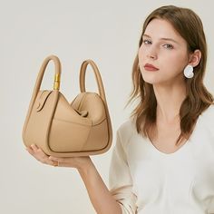 Looking for a versatile shoulder bag that oozes style and quality? Look no further than the Kelly Shoulder Bag! Lightweight and versatile, this bag is perfect for any occasion while easily fitting all your essentials. Whether dressed up or down, you'll confidently go anywhere with this must-have statement piece on your shoulder. Now available in beige and khaki. On-the-go Crossbody Baguette Bag With Top Handle, Versatile Large Capacity Beige Baguette Bag, Versatile Beige Box Bag With Removable Pouch, Versatile Top Handle Baguette Bag With Large Capacity, Versatile Hobo Bag With Top Carry Handle For Office, Versatile Baguette Bag With Large Capacity And Top Handle, Trendy Top Handle Shoulder Bag For On-the-go, Versatile Satchel Shoulder Bag With Top Carry Handle, Versatile Large Capacity Satchel Baguette Bag