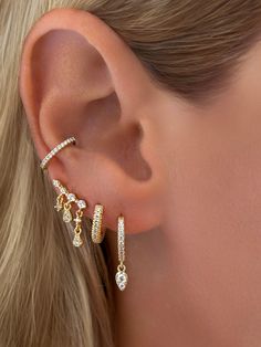 A unique and beautiful statement piece. Whether you're wearing this stunning earring alone or stacked- it's sure to stand out. Styled on our founder, Emily withFine White Topaz Dangle Chain Stud EarringsVermeil Triple Row Pavé CZ HuggieVermeil Teardrop Dangle Huggie Earrings Size: Length: Longest Drop 13mm ( approximately 1/2 inch)Stone: Cubic ZirconiaMaterials: Sterling Silver & 14K Gold Vermeil Fine Jewelry Tarnish Resistant Drop Cartilage Earrings, 14k Gold Dangle Jewelry With Matching Earrings, 14k Gold Dangle Earrings With Matching Set, Single Long Drop Cubic Zirconia Earring, Party Huggie Single Earring, Party Single Huggie Earring, Cubic Zirconia Dangle Earrings With Charms, Cubic Zirconia Drop Earrings With Dangling Charms, Elegant 14k Gold Jewelry With Dangling Charms