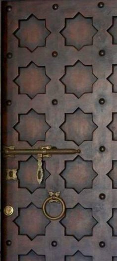 the door is made out of metal and has an intricate design