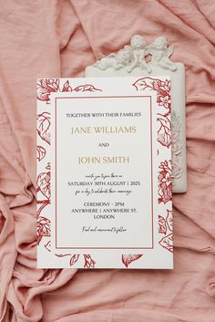 a wedding card on top of a pink sheet