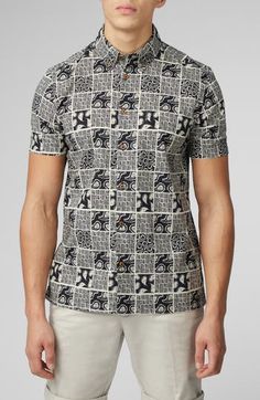 A checkerboard of paisleys and squiggles brightens a shirt made of soft cotton in a fit that looks great whether you wear it tucked or untucked. Front button closure Button-down collar Short sleeves Chest patch pocket 100% cotton Machine wash, tumble dry Imported Black Cotton Tops With Geometric Pattern, Black Cotton Top With Geometric Pattern, Casual Cotton Shirt With Abstract Print, Casual Shirt With Abstract Print And Spread Collar, Patterned Shirt With Relaxed Fit And Spread Collar, Patterned Shirt With Spread Collar And Relaxed Fit, Patterned Button-up Shirt With All-over Print, Patterned Shirt With Spread Collar In Relaxed Fit, Casual Patterned Shirt With Spread Collar