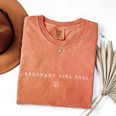 Celebrate the joy of a growing family with our "Pregnant Girl Fall Shirt," a cozy and stylish Comfort Colors tee perfect for your 2024 Fall Pregnancy Announcement. This charming New Baby Mommy Tee makes an ideal Fall Mom-to-Be Gift and a memorable Thanksgiving Baby Reveal!🎃 ♥ DESCRIPTION: This is a Comfort Colors Unisex t-shirt that is 100% ring-spun cotton, soft-washed, garment-dyed fabric brings extra coziness to your wardrobe while the relaxed fit makes it an excellent daily choice. The doub Family Matching Pink Tops For Fall, Cotton Crew Neck Bump Friendly Tops, Bump Friendly Cotton Tops For Gender Reveal, Personalized Casual Tops For Gender Reveal, Bump Friendly Cotton Crew Neck Top, Casual Cotton Maternity Tops, Casual Maternity Cotton Tops, Thanksgiving Pregnancy Outfit, Thanksgiving Maternity Shirt