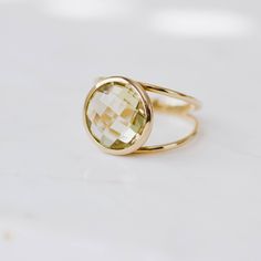 Lemon Quartz ring with double band in 14K solid gold. A modern and timeless stone ring with a natural quartz gemstone. A perfect gem gold ring for women, dainty and subtle that adds glam to every outfit. The best for her. 100% handcrafted with love! D E T A I L S ● Metal: 14K solid gold or 14K white gold or 14K rose gold ● Gemstone: Lemon Quartz, briolette cut ● Stone Diameter: 10mm (0.4in) or 12mm (0.5in) R I N G ∙ S I Z I N G For General Reference: ● we use standard US Ring Sizing ● an average Modern Gold Rings With Round Stone, Modern Gold Gemstone Birthstone Ring, Modern Gold Birthstone Ring With Gemstone, Modern Gold Ring With Round Stone, Modern Gold Crystal Ring With Gemstone, Elegant Gold Rings With Green Amethyst, Elegant Yellow Gold Green Amethyst Rings, Elegant Gold Faceted Birthstone Ring, Elegant Gold Ring With Green Amethyst