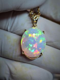 Big pink  white opal  17x20mm   14.67ct. Pretty and bright lovely floral pattern of 3D color in a pink, purple cloud of stone, mounted on a very simple low profile 14k solid gold pendant setting with a nice simple shiny bail. I can mount it on a smaller pendant if you wish, where there is no mount visible top and bottom. White Opal Pendant Jewelry, White Opal Gemstone Necklace, White Oval Opal Necklace, Elegant White Pink Opal Jewelry, White Pink Opal Gemstone Jewelry, White Ethiopian Opal Gemstone Jewelry, White Ethiopian Opal Gemstone Necklace, Handmade White Opal Necklaces, White Opal Cabochon Necklaces