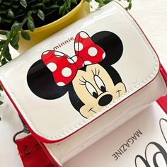 Add Some Magic To Your Style With This Charming Disney Mickey & Minnie Mouse Mini Crossbody Bag! Perfect For Disney Enthusiasts Of All Ages, This Waterproof Purse Boasts An Iconic Mickey Mouse Face On A Crisp White Backdrop, Complemented By A Vibrant Red Adjustable Strap For Comfort And Convenience. Whether You’re Running Errands Or Heading To The Parks, This Delightful Bag Is Sure To Turn Heads And Keep Your Essentials Safe In Any Weather. White Cartoon Style School Bags, Cartoon Style White School Bag, Disney White Bags For Disney Trips, Disney School Bag In Red, Disney Red School Bag, Red Disney School Bags, Cute Rectangular Minnie Mouse Bags, Cute Mickey Mouse Bags For Gifts, Cute Mickey Mouse Bags As Gift