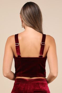 Keep things sultry-chic all night long in the Blank NYC Sneak Peak Burgundy Velvet Bustier Crop Top! Soft, plush velvet shapes this party-ready top with wide adjustable straps and a sweetheart neckline. Fitted, bustier-inspired bodice features seamed cups and flattering stitching before ending at an ultra-cropped hem. Hidden side zipper. Pair with the matching pants for a complete look! Fit: This garment fits true to size. Length: Size medium measures 9.75" from adjustable straps to hem. Bust: Works best for A to C cup sizes - consider sizing up for fuller bust. Waist: Fitted - very fitted at natural waist. Undergarments: May be worn with a strapless bra, adhesive bra, petals, or no bra. Fabric: Fabric has no stretch. Lined. Shell: 95% Polyester, 5% Spandex. Lining: 97% Polyester, 3% Spand Cropped Evening Corset With Corset Back, Cropped Corset With Corset Back For Evening, Party Cropped Corset With Boned Bodice, Elegant Cropped Corset For Parties, Cropped Party Corset With Boned Bodice, Elegant Cropped Corset For Evening, Elegant Cropped Evening Corset, Elegant Crop Top With Corset Back For Party, Elegant Party Crop Top With Corset Back