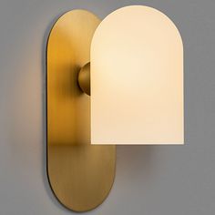 a wall light with a white shade on it's side and a gray background