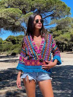 An astonishing boho summer jacket that has been hand woven with colorful tribal patterns. Perfect for lovers of eccentric statement pieces. Works amazingly well with solid colors as well as with bold prints such as animal prints. A unique, vibrant, piece, for people of style. Stylish elegant and bold, this jacket is a rare, statement piece that you will wear a lot and absolutely adore. In your vacations or in the city, this is key piece for your summer wardrobe. Our model, wears SIZE Medium and Hippie Style Multicolor V-neck Kimono, Bohemian Multicolor Patterned Kimono, Bohemian Patterned Multicolor Kimono, Long-sleeved Tassel Kimono For Festivals, Long Sleeve Kimono With Tassels For Festival, Long Sleeve Tassel Kimono For Festivals, Boho Print Outerwear For Beach In Spring, Spring Beach Outerwear With Boho Print, Boho Print Outerwear For Spring Beach