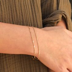 This is a set of layering bracelets inspired by our Shoreline and Shoreline Toggle Necklace. These bracelets look stunning when layered together but also when each bracelet is worn individually or with other bracelets to complete your fabulous look. Made out of high quality gold filled materials and perfect for everyday wear. One set of two chain bracelets: Spring ring clasp (6mm) 14K gold filled chain 1" extender option available Nickel-free Adjustable Double Strand Gold Chain Bracelet, Adjustable Gold Double Chain Bracelet, Trendy Double Band Gold Bracelets, Trendy Gold Double Band Bracelets, Gold Wrap Bracelet For Layering, Adjustable Chain Bracelets For Layering, Adjustable Double Chain Bracelet For Everyday, Layering 14k Gold-filled Yellow Gold Bracelets, Minimalist Adjustable Double Chain Bracelet