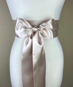 "Champagne Satin Sash  Wide Champagne Sash Belt  Satin Obi Sash Belt  Bridal Sash, Bridesmaid Sash  Champagne Wedding Dress Sash  Satin Swank  Make this Satin Swank® reversible waist sash the perfect finishing touch for your wedding, bridesmaid, or special occasion dress, or just the right piece to add instant polish to your dress or top.  This extra long version is 3.5 inches wide, 120 inches long, and will wrap around most waist sizes two times with a generous length remaining to tie in a bow or a simple knot with long-hanging tails.  Tie in front or in back.   Silky charmeuse satin fabric in champagne, this sash is the same front and back with ends finished on the angle and seams hidden within the fold lines. SIZING/COLOR/PRINT INFO: Sash Measurements: 3.5\" wide, 120\" long (point to p Champagne Wedding Dress, Obi Sash, Bridesmaid Sash, Wedding Dress Sash, Wedding Dress Champagne, Wedding Sash Belt, Waist Sash, Satin Sash, Dress Sash