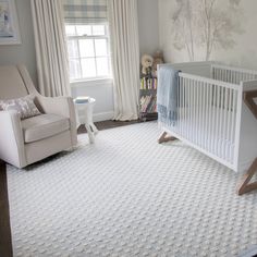 a baby's room with a crib, rocking chair and bookshelf