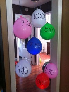 balloons with numbers hanging from the ceiling in front of an open door and a doorway