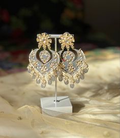 A perfect grey kundan/chandbali earring for your next event! Luxury Meenakari Temple Jewelry Pearl Earrings, Festive Silver Chandelier Earrings With Stone Work, Silver Kundan Necklace With Gota Work For Gift, Silver Chandelier Earrings With Stone Work For Festivals, Zari Work Danglers For Party And Festivals, Zari Work Danglers For Festivals And Parties, Silver Kundan Jhumkas For Party, Silver Kundan Necklace With Gota Work For Festivals, Silver Kundan Bridal Earrings For Eid