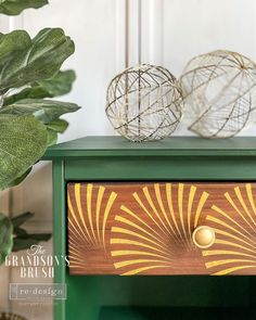 two decorative balls on top of a green dresser