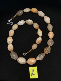 A beautiful string of Bended white agate natural found from Afghanistan dating 1800 yrs. They are found at that time in Afghanistan mostly but also some found in India and Pakistan too. They were used as a special charm jewellery by the affluents at that time period. Beautiful counter bronze are decorated further in between the beads. Artisan White Oval Beads Jewelry, White Oval Beads Artisan Jewelry, White Polished Beads Jewelry For Healing, Spiritual Tumbled Agate Jewelry, Spiritual Tumbled Gemstone Beads Jewelry, White Jewelry With Natural Oval Stone Beads, White Jewelry With Natural Oval Beads, White Jewelry With Oval Natural Stones, Rondelle Agate Jewelry With Natural Stones