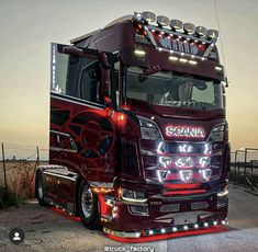 a red semi truck parked on top of a road