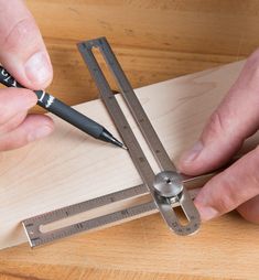 a person using a ruler to measure wood