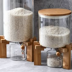 two jars with rice in them sitting on wooden stands