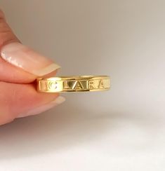 PERSONALIZED NAME and WORD RING This minimalist and Dainty custom Name Ring, Minimalist Name Ring can be worn every day. Personalize this ring with your name, Roman numerals, coordinates and words. Simple and elegant design makes a perfect gift for all special occasions! FEATURES Material: Crafted in 18K Gold plated .925 Sterling Silver and 14K solid Gold Color: Silver, Gold, Rose Gold The item will come with a gift box. The premium hand formed ring is 4mm wide and 1mm thick All our jewelry is % Custom Name Initial Ring For Engagement, Luxury Statement Engraved Ring Gift, Engraved Rings Personalized Wedding, Custom Name Ring, Engraved Rings Personalized, Ring For Women Gold, Roman Numeral Ring, Mantra Ring, Couple Ring Design